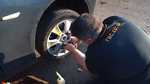 RAC Mechanic changing a wheel Stock Footage 106137210