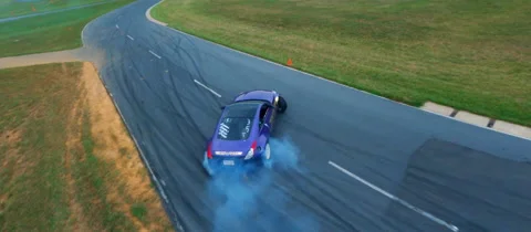 Race car drifting through turn - FPV Drone 4K Stock Footage 231734741