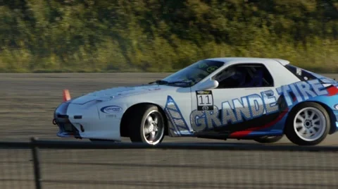 Race car drifts around corners in slow motion at drifting event. Video stock 59747052