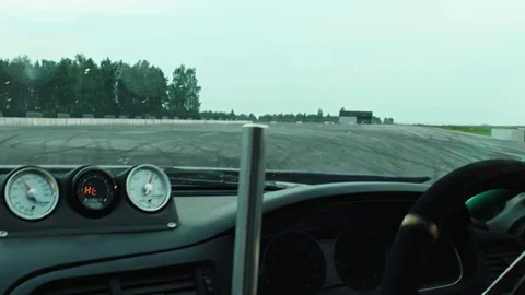 Race car driver loses control of track and the car skids to the side of the road Stock Footage 123601289