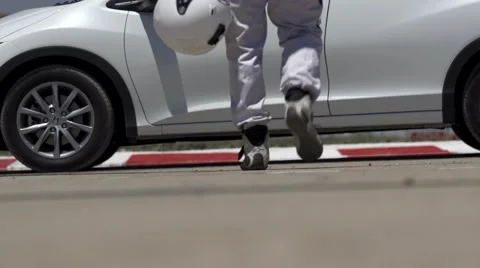 Race car driver walking to the car low shot Stock Footage 41267093