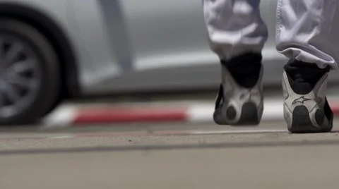 Race car driver walking to the car - focus on legs Stock Footage 41361696