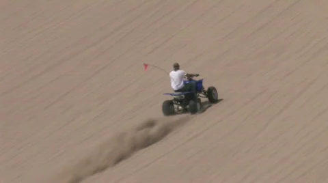 Race to top of sand dune ATV M HD Stock Footage 140093