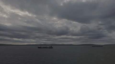 To the race wind terrible clouds over the sea. In the sea there are ships. Stock Footage 142759940