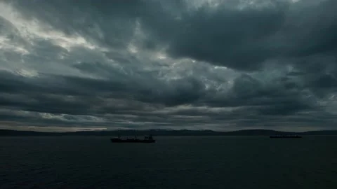 To the race wind terrible clouds over the sea. In the sea there are ships. Stock Footage 142760751