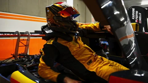 Racecar driver preparing to start. Putti... | Stock Video | Pond5