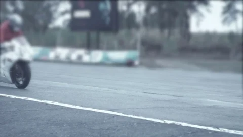 Racer coming through a strait part of moto track Stock Footage 70323143