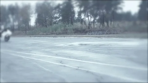 Racer on a white bike carries abrupt turn Stock Footage 70323053