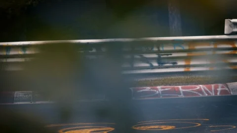 Racetrack surrounded by forest. Looking through fence. Speeding cars Stock Footage 111425585