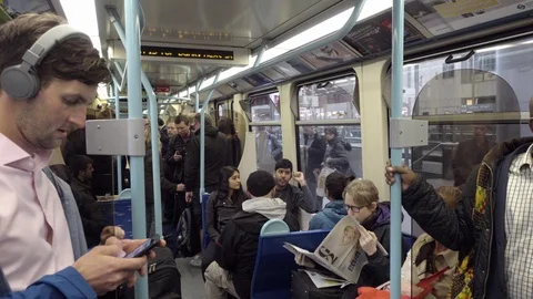Racial diversity man listening to headphones smartphone on London metro train Stock Footage 92498124