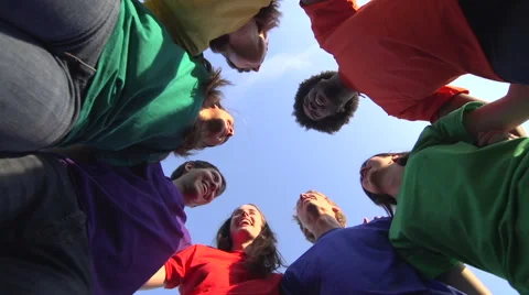 Racially-diverse group in colored t-shirts laugh and chat. Stock Footage 44105129