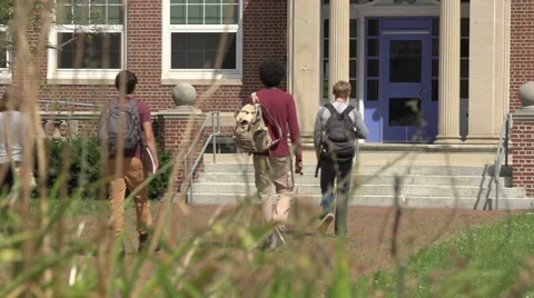 A racially-diverse group of students enter a school. Stock Footage 44117305