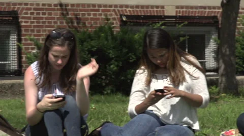 Racially-diverse students obsessively using cell phones. Stock Footage 44117276