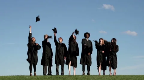 Racially-diverse students throw mortarboards - wide - slow motion Stock Footage 44112313