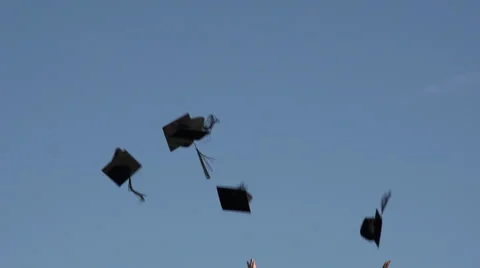 Racially-diverse students throw mortarboards into the sky - slow motion Video stock 44112414