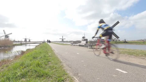 Racing bicycle Driving Through World Heritage Site Kinderdijk During Corona Stock Footage