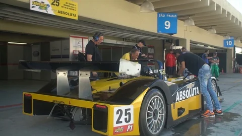 A racing car being checked over, before heading to the track at the Stock Footage 98357383
