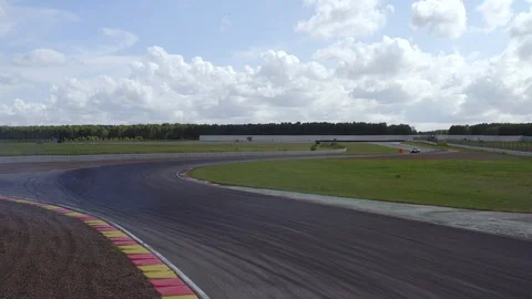 Racing car driving on speed rack. Aerial... | Stock Video | Pond5