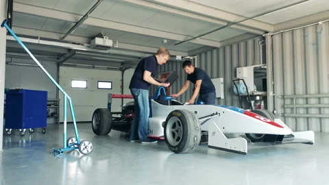 Racing car is getting checked by garage specialists Stock-Footage 162883738