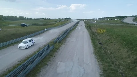 Racing car performs jump in slow motion aerial Stock Footage 89416437