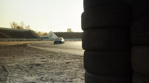 A racing car stands in the middle of an abandoned stadium Stock Footage 248183320