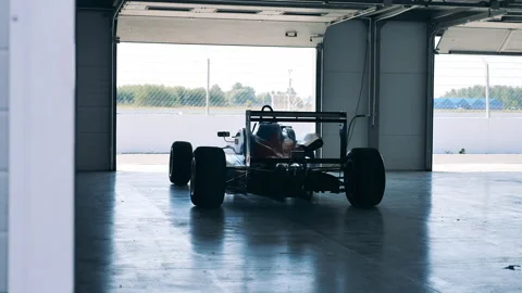 Racing cart in the workshop with nobody inside Stock Footage 163504127