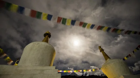 Racing clouds stupas and prayer flags at night in Nepal near Khumjung Stock Footage