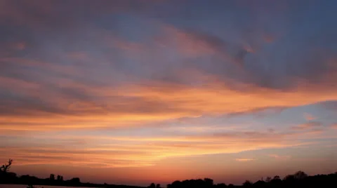 Racing clouds at sunset Stock Footage 26276480