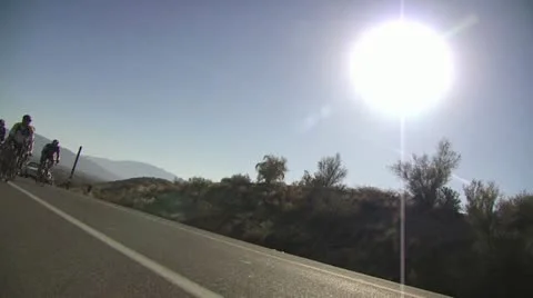 Racing Cyclists Coming Down A Hill On A Very Sunny Day 스톡 동영상 19140860
