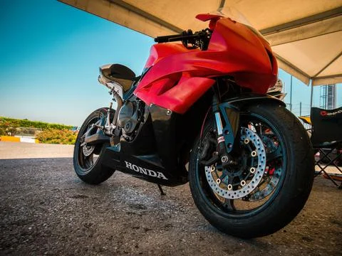 Racing driver on the track with his red bike Stock Photos