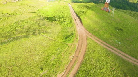 Racing drone flying over green field and river Stock Footage 166058711
