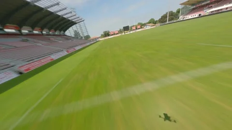 Racing drone flying over green field of Parc des Sports Aguiléra stadium Stockbeeldmateriaal 308232715