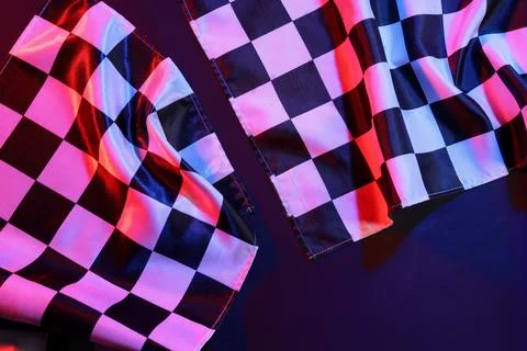 Racing flags on dark colorful background, closeup Stock Photos