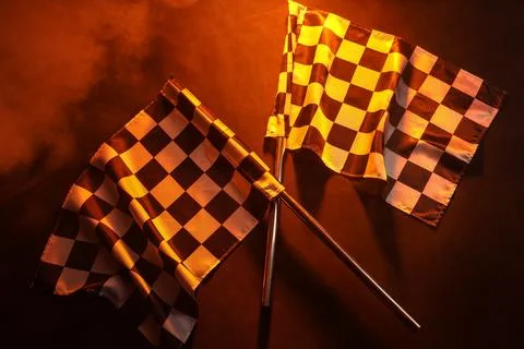 Racing flags on orange background Stock Photos