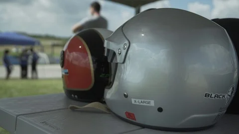 Racing Helmets on Bench at Race Track Motorsports Color Video stock 120149589