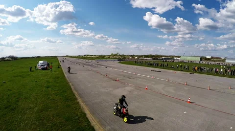 Racing scooters go fast under camera Stock Footage 52338604