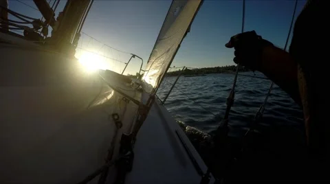Racing in the setting sun POV sitting on starboard site on a port tack moving Stock Footage 67490754