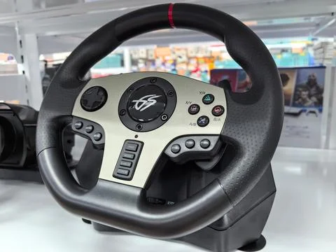 A racing simulation wheel rests on a display shelf in a gaming store Stock Photos