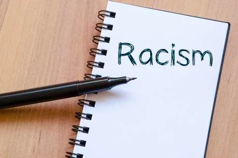 Racism write on notebook Stock Photos