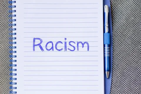 Racism write on notebook Stock Photos