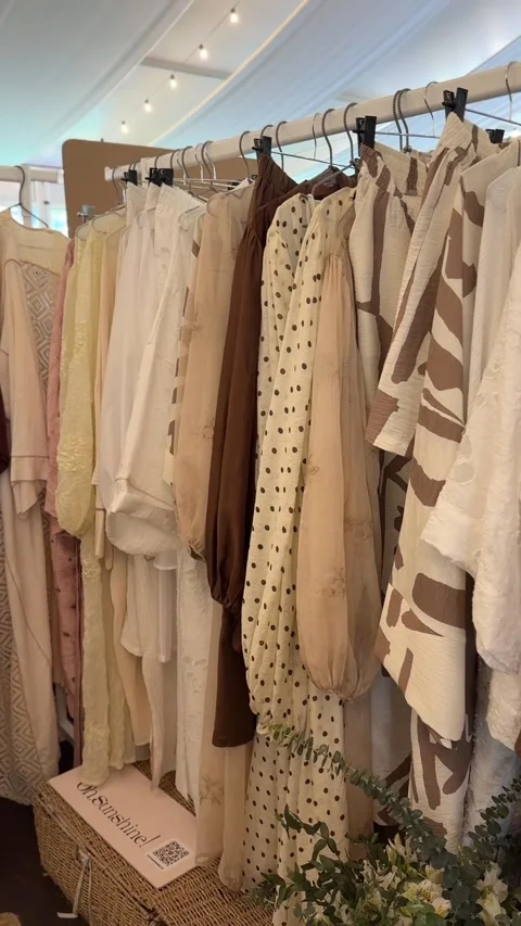 Rack of bohemian-style dresses with various earthy tones and patterns, idea.. Stock Footage 336274121