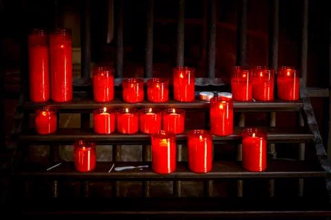 Rack with candles in front of cathedral Stock Photos