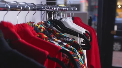 Rack of designer clothes, hand comes to grab one of the jackets Stock Footage 85232331
