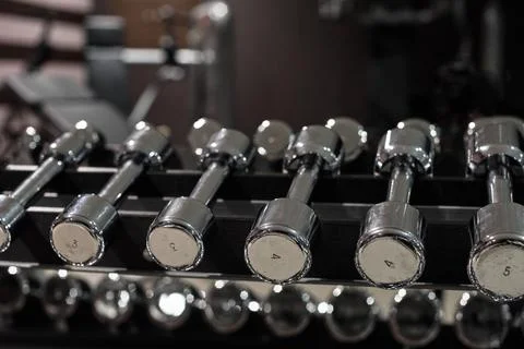 Rack with different dumbbells Stock Photos