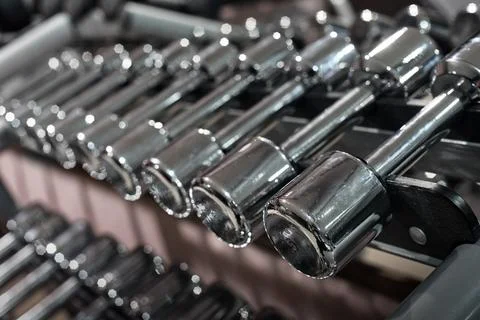 Rack with different dumbbells Stock Photos