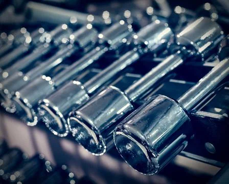 Rack with different dumbbells Stock Photos