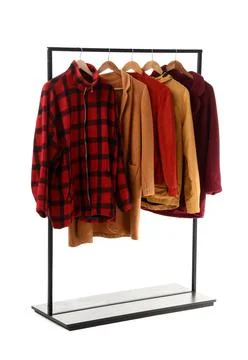 Rack with different jackets on white background Foto stock