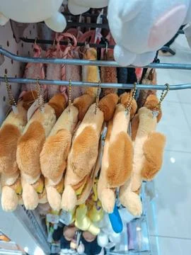 A rack displaying soft plush keychains shaped like cute animal bread slices.. Stock Photos