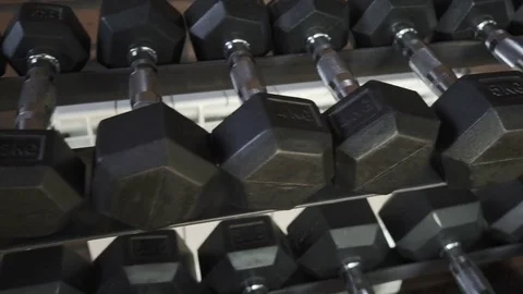 Rack with dumbbells in the gym Stock Footage 84036373