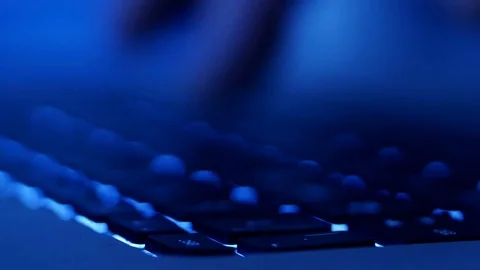 Rack focus across man typing on computer keyboard  Stock Footage 85065769